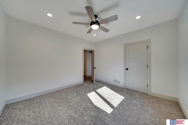 unfurnished bedroom featuring ceiling fan, recessed lighting, light colored carpet, visible vents, and baseboards