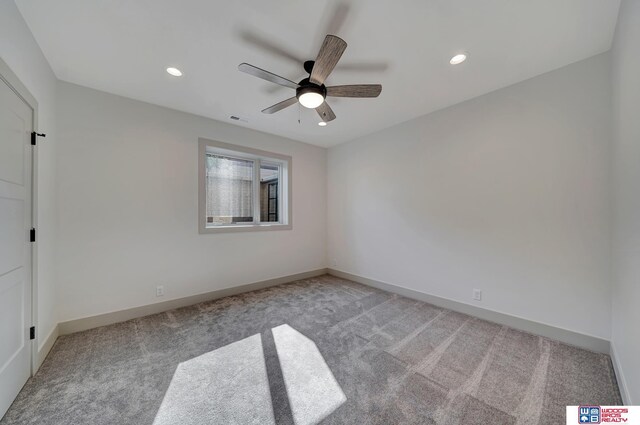 spare room with baseboards, visible vents, carpet flooring, and recessed lighting