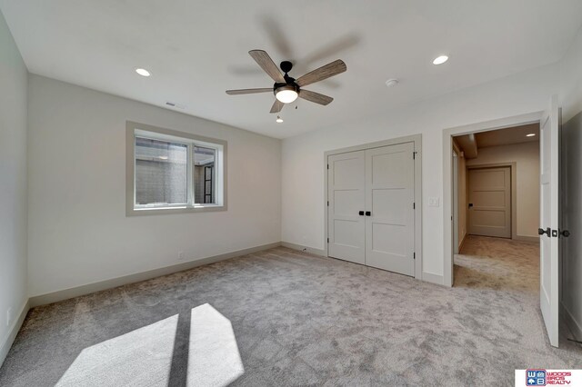 unfurnished bedroom with carpet, visible vents, and baseboards