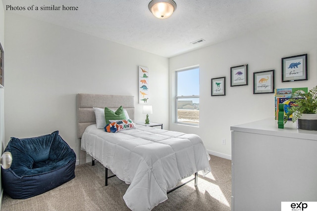 carpeted bedroom with a textured ceiling