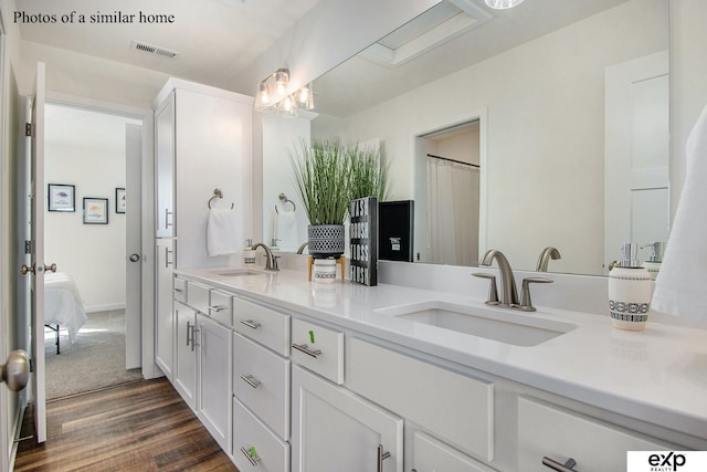 bathroom featuring vanity and wood-type flooring