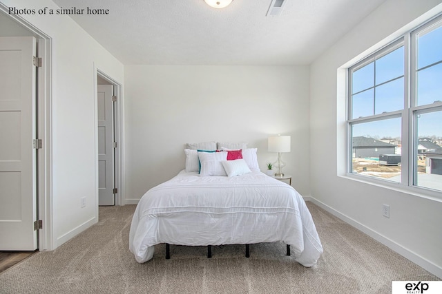 carpeted bedroom featuring a textured ceiling