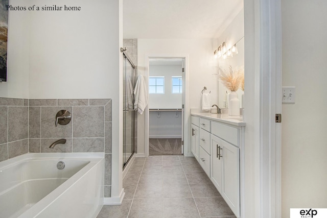 bathroom featuring vanity, tile patterned flooring, and shower with separate bathtub