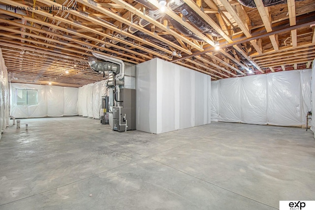 basement featuring heating unit and water heater