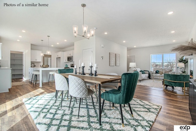 dining area with an inviting chandelier and hardwood / wood-style floors