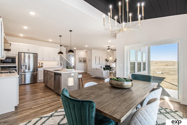 dining room featuring ceiling fan, dark hardwood / wood-style flooring, and sink