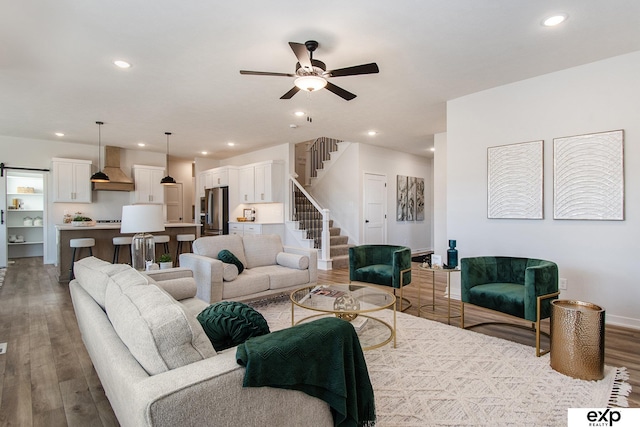 living room with light hardwood / wood-style floors and ceiling fan