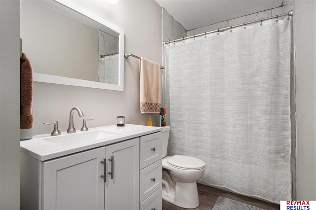 bathroom featuring vanity, hardwood / wood-style floors, and toilet