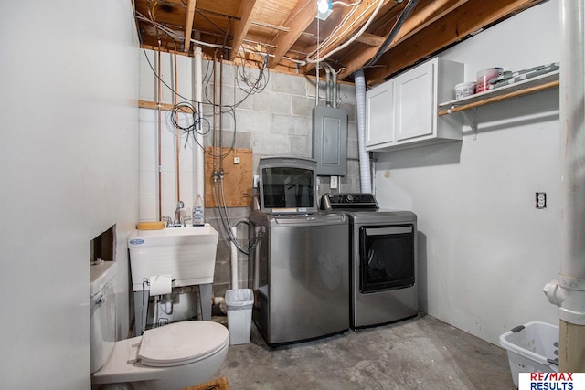 laundry room featuring cabinets, sink, electric panel, and independent washer and dryer