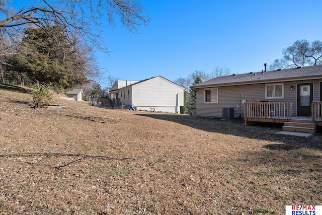 view of yard with a wooden deck and central AC