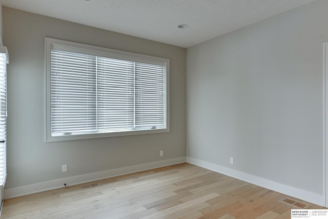 spare room with light hardwood / wood-style flooring