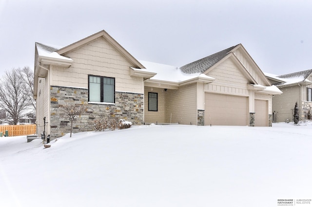 view of front of house with board and batten siding, stone siding, and an attached garage