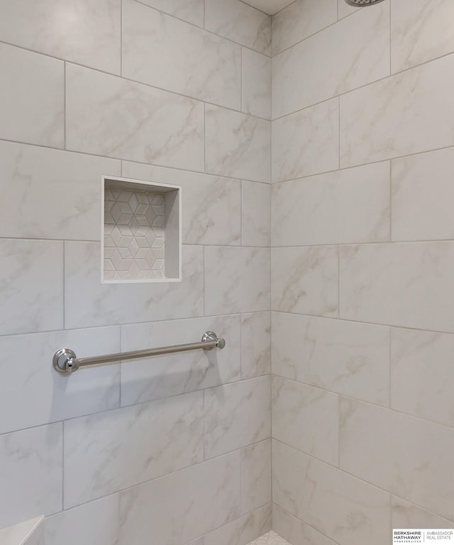 bathroom with a tile shower