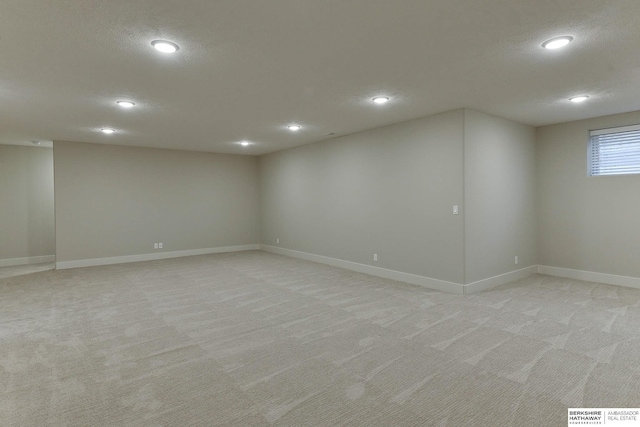 basement with light carpet and a textured ceiling