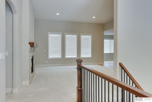 hallway with light colored carpet