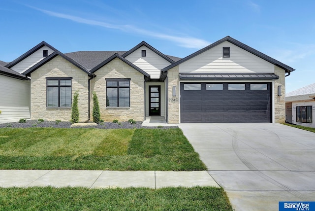 view of front of home with a garage and a front lawn