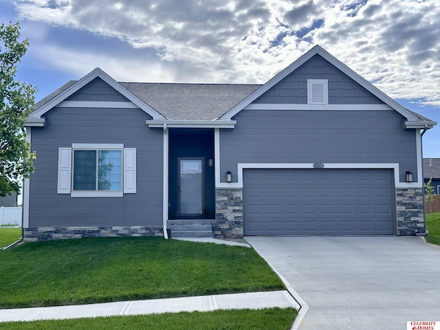 craftsman-style house featuring a garage and a front yard