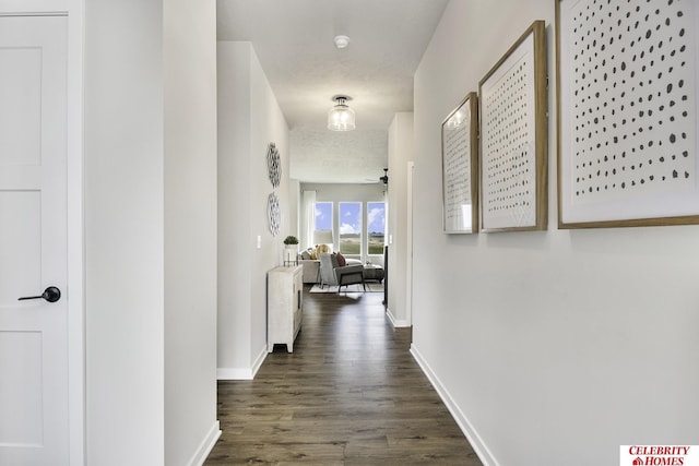 hall with dark hardwood / wood-style floors and a textured ceiling