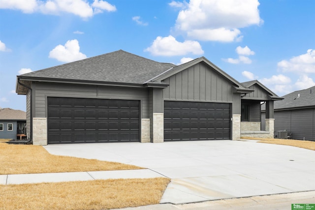 view of front of home featuring a garage and central air condition unit