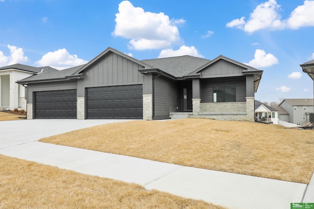 view of front of property with a garage, a front yard, and cooling unit