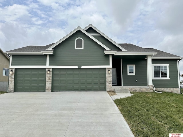 craftsman inspired home featuring a garage and a front yard