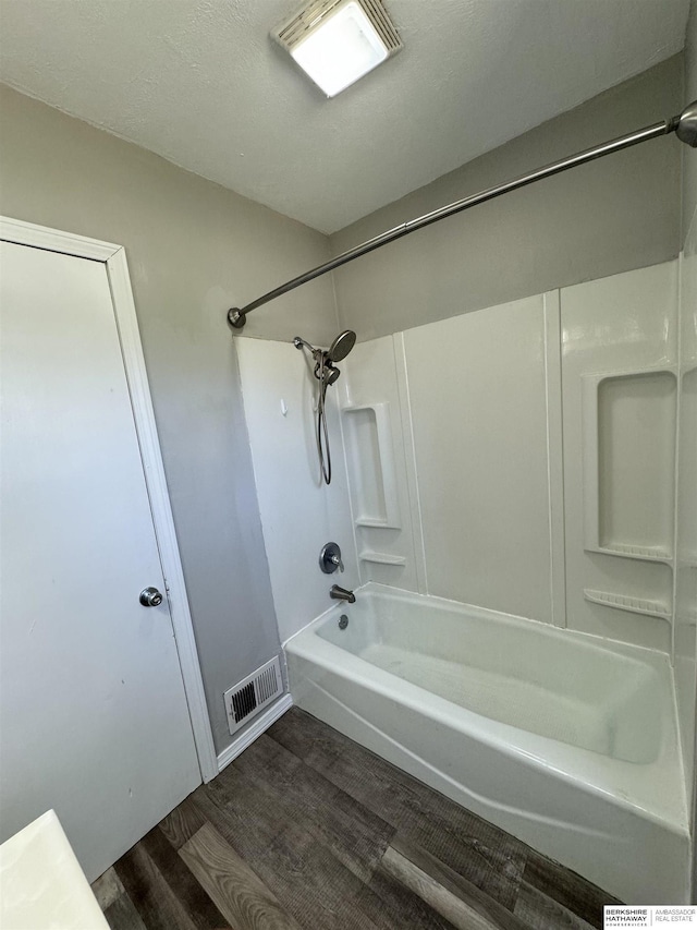 bathroom with wood-type flooring and shower / bathtub combination