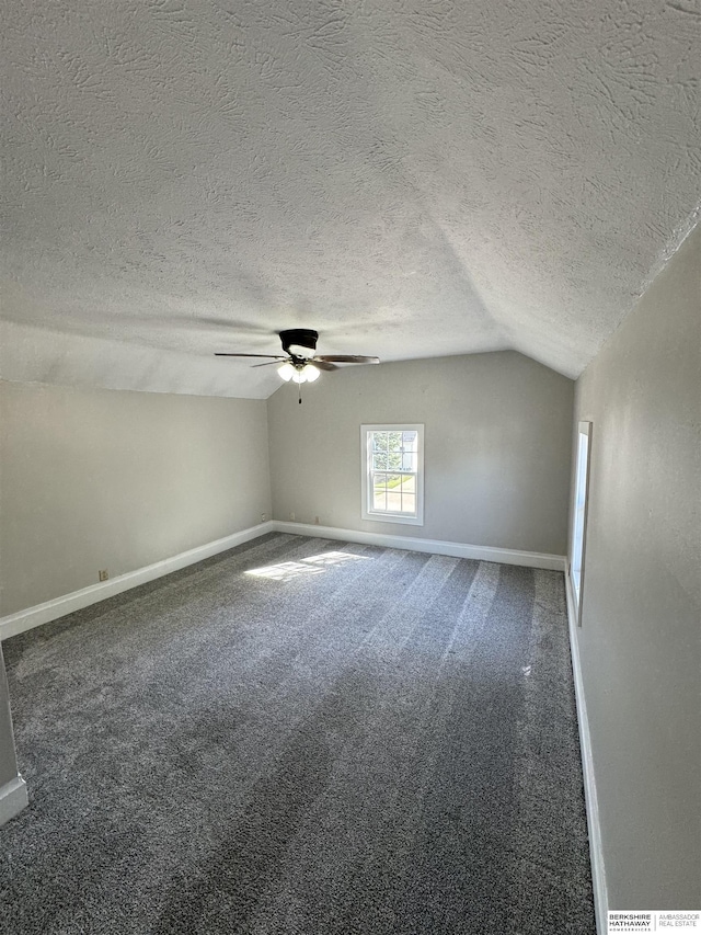 bonus room with ceiling fan, lofted ceiling, carpet floors, and a textured ceiling