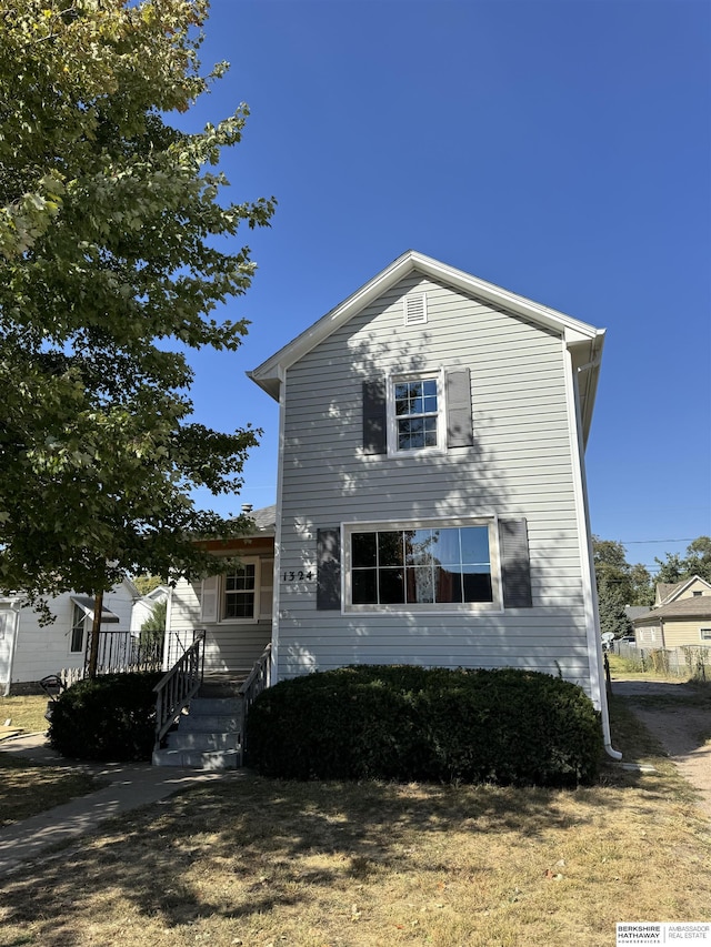 view of front of property with a wooden deck and a front yard