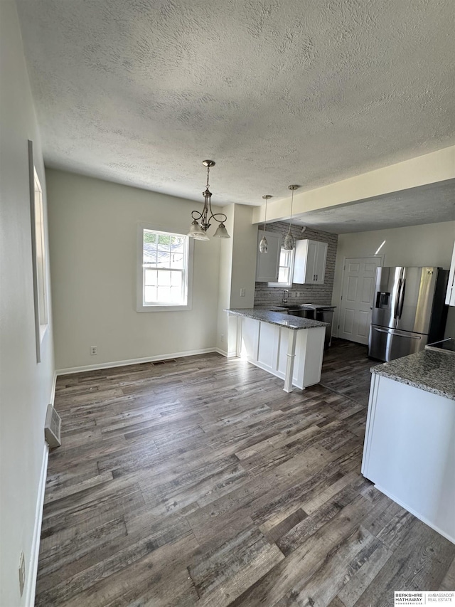 kitchen featuring decorative light fixtures, white cabinets, decorative backsplash, stainless steel fridge with ice dispenser, and dark wood-type flooring