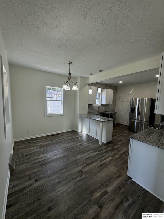 kitchen with white cabinetry, tasteful backsplash, stainless steel fridge with ice dispenser, hanging light fixtures, and dark hardwood / wood-style floors