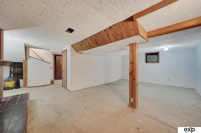 basement featuring a textured ceiling