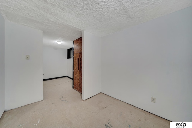 spare room featuring a textured ceiling