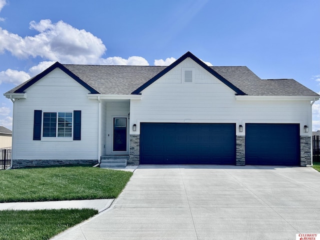 view of front of house with a garage and a front yard