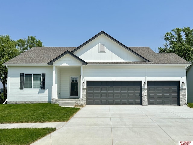 view of front of house featuring a garage and a front lawn