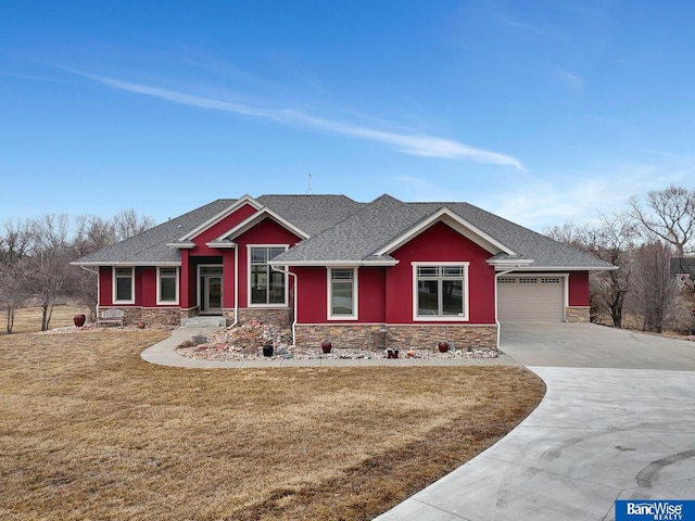 craftsman inspired home featuring a garage and a front lawn