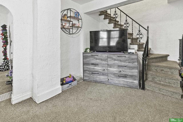 stairs featuring carpet floors