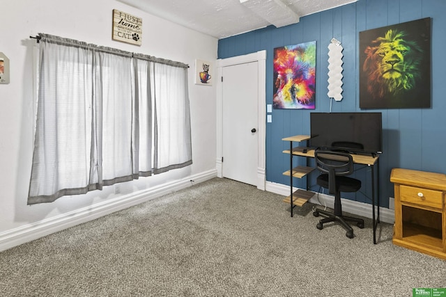 carpeted home office with a textured ceiling