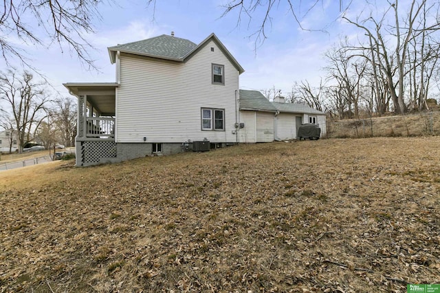 rear view of property featuring central AC unit