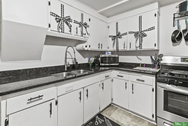 kitchen featuring sink, dark stone counters, white cabinets, and appliances with stainless steel finishes