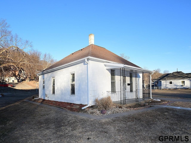 view of side of property with a porch