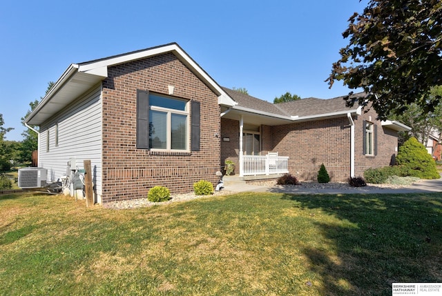 view of front of home featuring a porch, central AC unit, and a front lawn