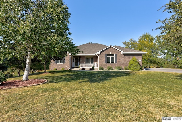 single story home with covered porch and a front lawn