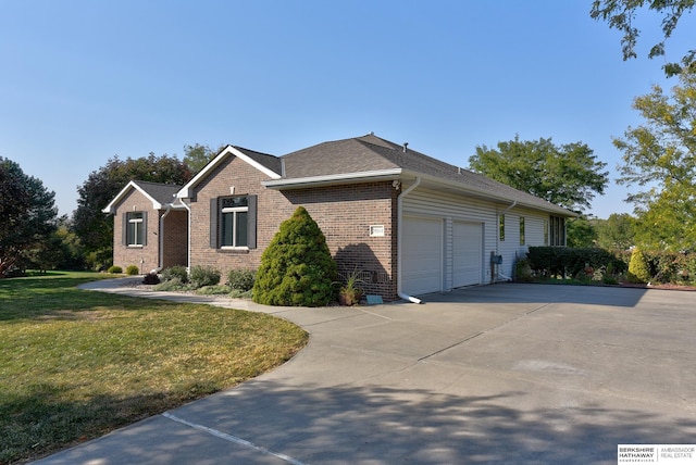 view of front of property featuring a garage and a front lawn