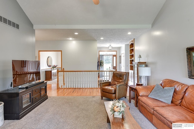 carpeted living room featuring built in shelves and a textured ceiling