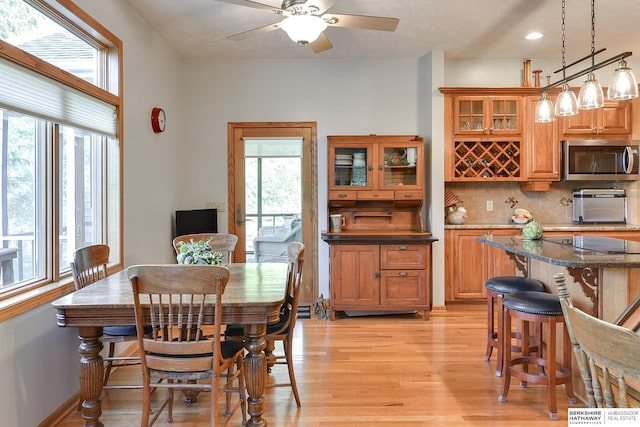 dining room featuring ceiling fan and light wood-type flooring