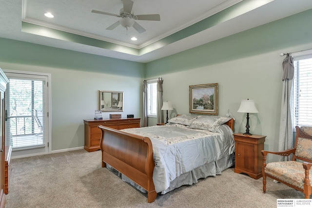 bedroom featuring light carpet, crown molding, and a raised ceiling