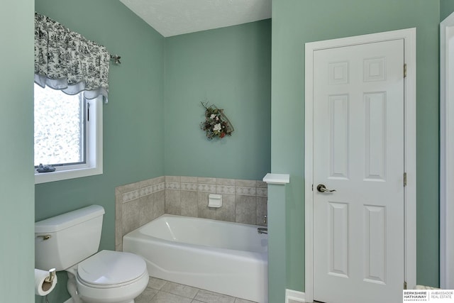 bathroom with tile patterned floors, toilet, and a bathing tub