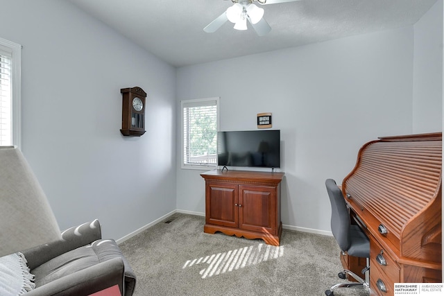 office area featuring light carpet and ceiling fan