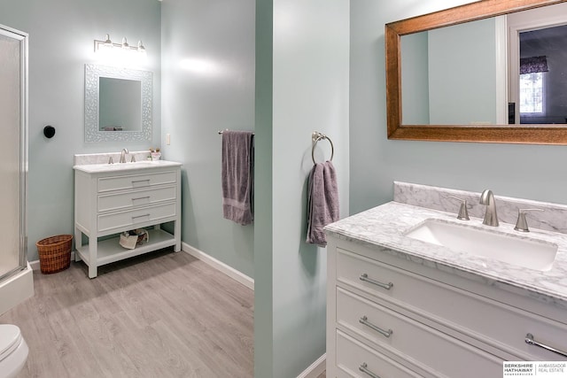 bathroom with vanity, hardwood / wood-style floors, and toilet