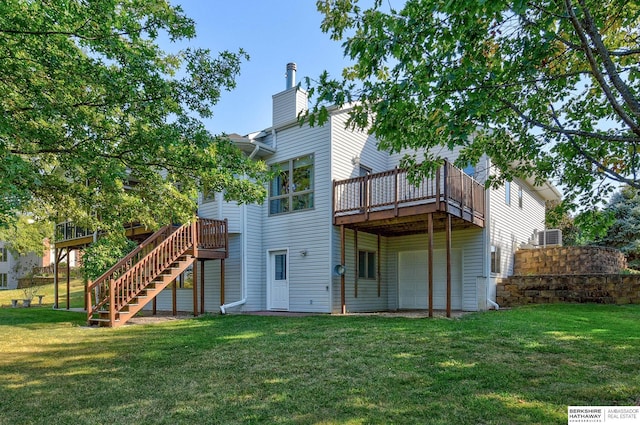 rear view of property featuring a wooden deck and a yard